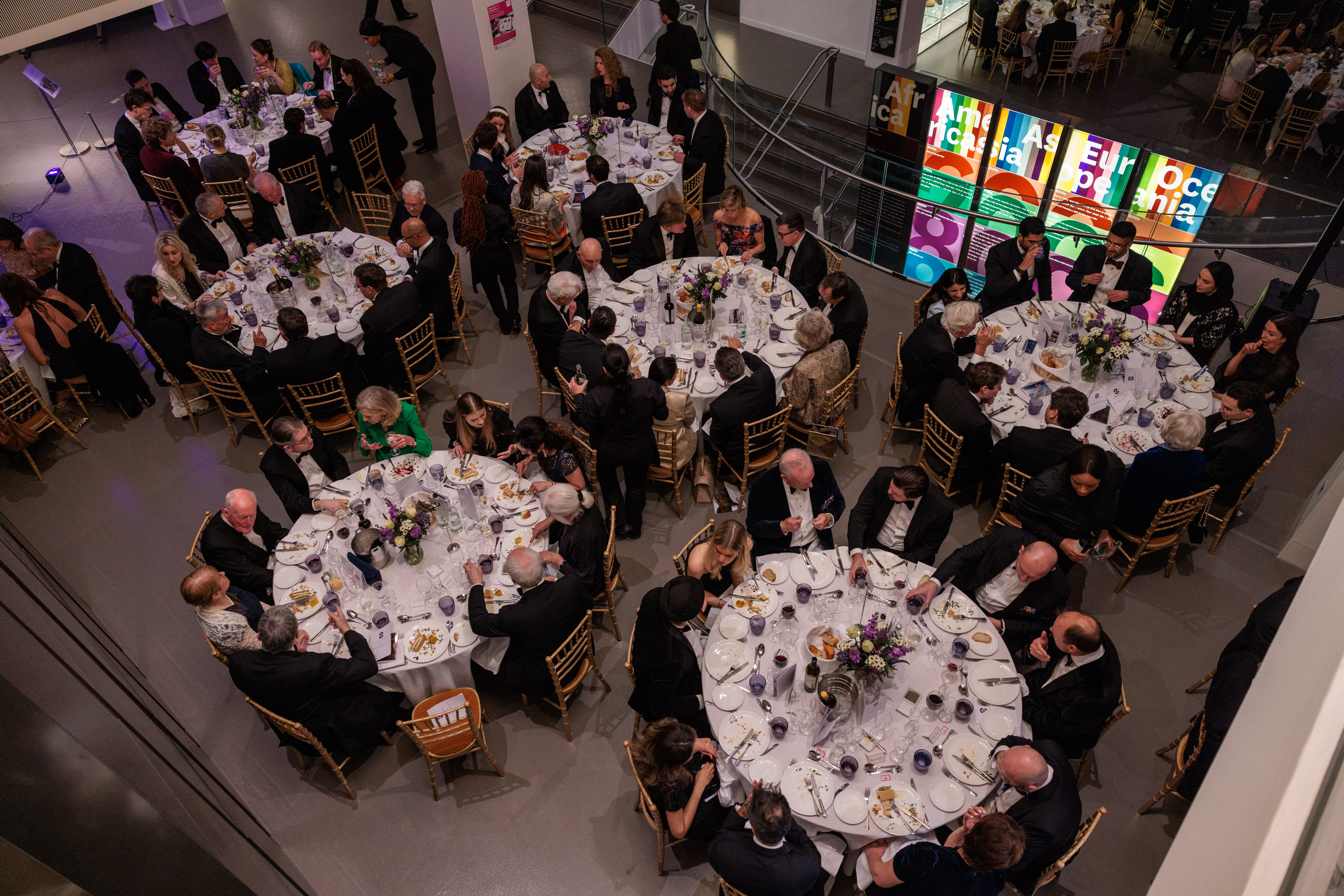 A guest reads the event brochure at a beautifully set table